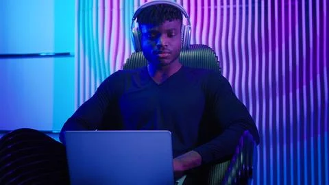 Hacker programmer computer worker gamer African American man in headphones male Stock-Fotos