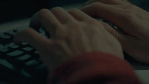 A hacker programmer in extreme close-up writes code on a laptop computer whi Stock Footage 254891348