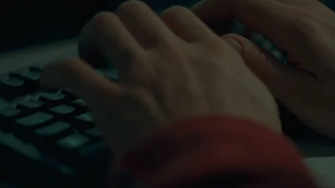 A hacker programmer in extreme close-up writes code on a laptop computer whi Stock Footage 323708753