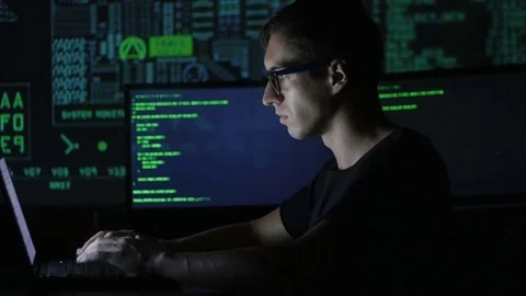 Hacker programmer in glasses is working on computer in cyber security center Stock Footage 80267675