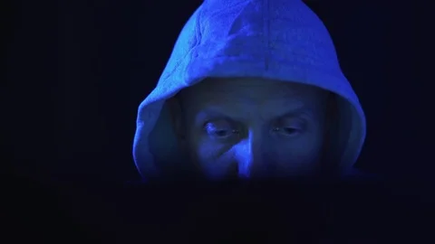 A hacker programmer, at night at a laptop computer, creates virus hacking Stock Footage 122321517