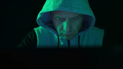 A hacker programmer, at night at a laptop computer, creates virus hacking Stock Footage 124098373
