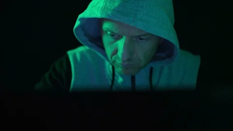 A hacker programmer, at night at a laptop computer, creates virus hacking Stock Footage 124233437