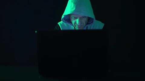 A hacker programmer, at night at a laptop computer, creates virus hacking Stock Footage 124619335