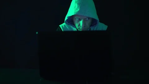 A hacker programmer, at night at a laptop computer, creates virus hacking Stock Footage 125681043