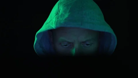 A hacker programmer, at night at a laptop computer, creates virus hacking Stock Footage 126169407