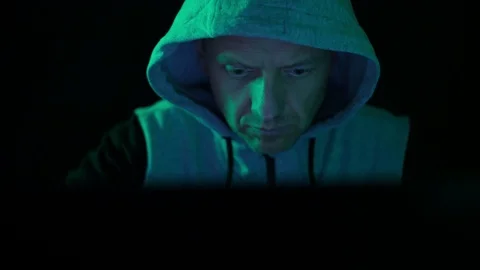 A hacker programmer, at night at a laptop computer, creates virus hacking Stock Footage 127540081