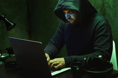 Hacker programmer using computer in dark room Stock Photos
