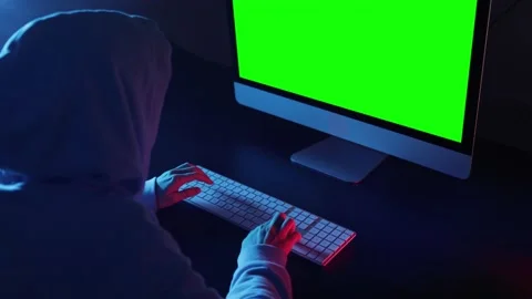 Hacker programmer wearing a hood, typing very fast intelligible code. Stock Footage 145472957
