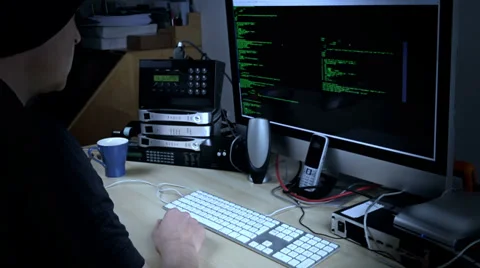 Hacker programmer at work on computer with streaming code on screen Stock Footage 35155741