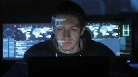 Hacker programmer is working on computer in cyber security center filled with Stock Footage 86882223