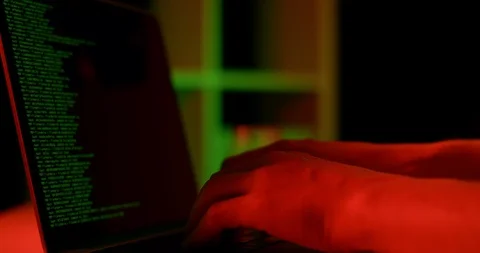 Hacker Programmer Working On The Notebook Laptop Under Red And Green Lights Stock-Footage 105466737