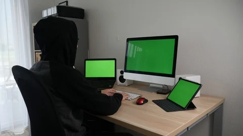 Hacker programmer working tirelessly on green screens Stock Footage 127456800
