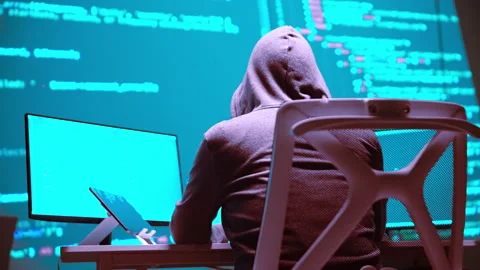 Hacker Programming at a Computer with Code on Screen in a Cybersecurity Env.. 動画素材 336678766