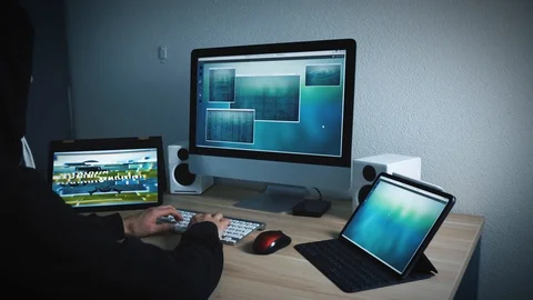 Hacker programs a dangerous computer virus. Skull appears on the monitor. Stock Footage 127456813