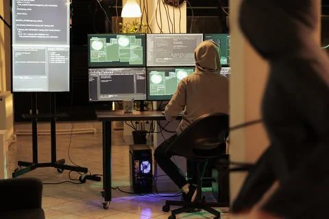 Hacker running malicious software code on computer, hacking database Stockfoto's