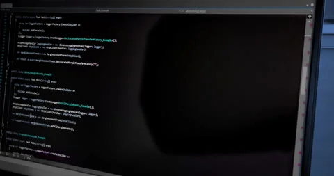 Hacker scrolls program code on notebook computer, cyber security concept Stock Footage 275822082
