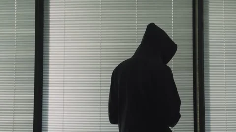 Hacker silhouette by window using phone to type message or secret email digital Stock Footage 331464295