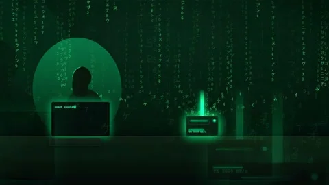 Hacker silhouette working on computer with green digital code rain and data Video stock 343154111