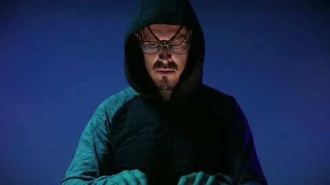 Hacker sitting alone in front of the computer in a dark room Stock Footage 142991796