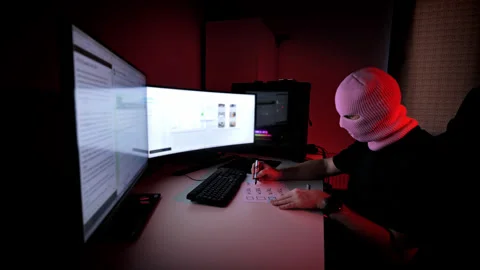 Hacker Sketching Future Plans on Paper - Dimly Lit Room With Red Ambient Light Stock Footage 306662455