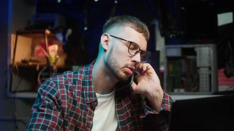 Hacker speaking on phone. Programmer talking on smartphone close-up, calling Stock Footage 166858371