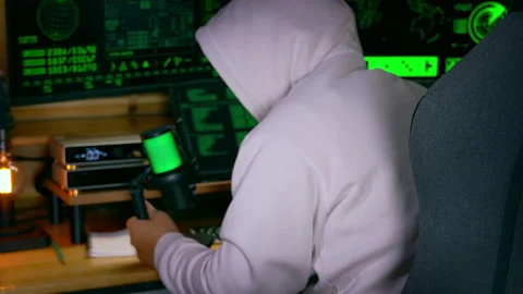 Hacker speaks into microphone during tense cyber operation 60fps Stock Footage 312968585