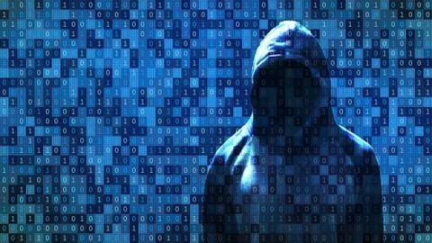Hacker standing in front of 01 or binary numbers on the computer screen on mo Foto stock