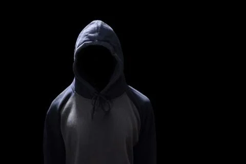 Hacker standing isolated on black background. Human anonymous in safety secur Stock Photos