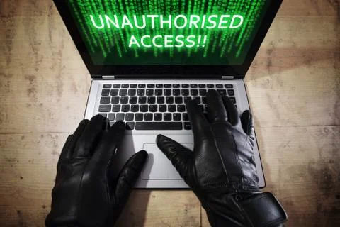 Hacker stealing data from a laptop Stock Photos