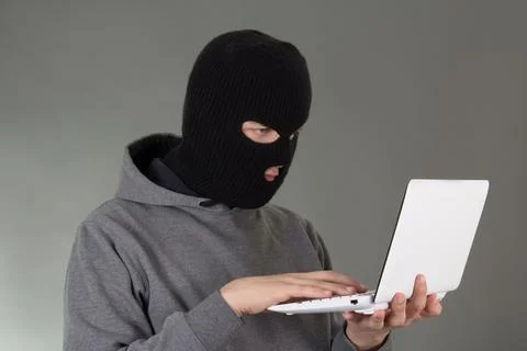 Hacker stealing data from white laptop Stock Photos