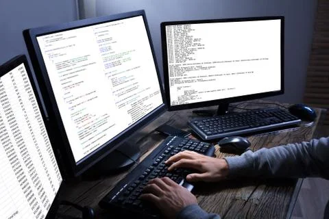 Hacker Stealing Information From Multiple Computers Stock Photos