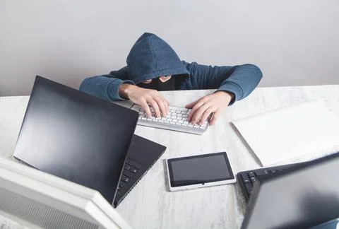 Hacker stealing information from the office computer. Hacking, Criminal Stock Photos