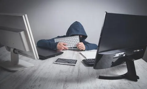 Hacker stealing information from the office computer. Hacking, Criminal Stock Photos