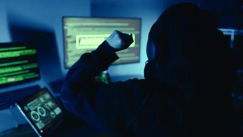 Hacker successfully using code designing virus system, raised hands celebrating. Stockfoto's