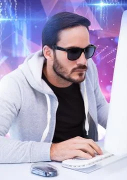 Hacker with sunglasses typing on a keyboard in front of digital background Stock Photos