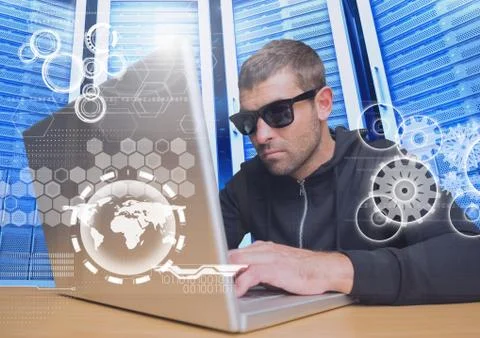Hacker with sunglasses using a laptop in data center Foto stock
