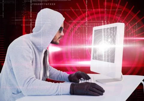 Hacker with sunglasses using a laptop in front of digital red background 写真素材