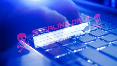 A hacker taps his finger on keyboard of a computer and downloads data from an Stock-Footage 124704318