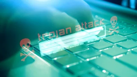 A hacker taps his finger on keyboard of a computer and downloads data from an Stock Footage 124704337