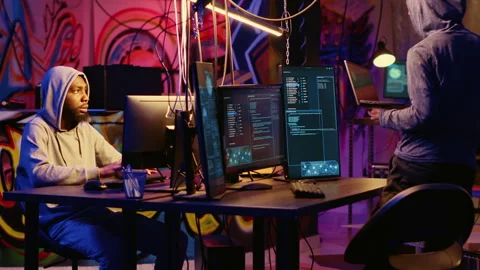 Hacker teaching beginner to hack PCs Stock Footage 256944821