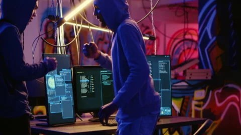 Hacker teaching new member how to crack Stock Footage 256940741