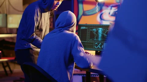 Hacker teaching youngster to hack PCs Stock Footage 256945216