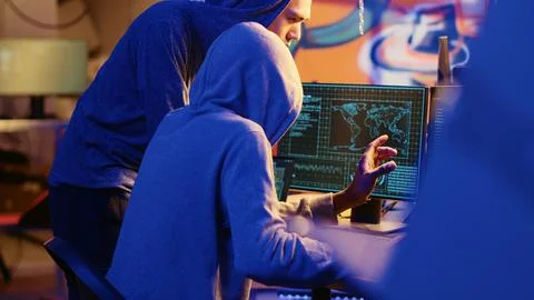 Hacker teaching youngster to hack PCs Stock-Fotos