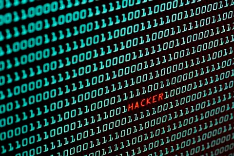 Hacker text and binary code concept from the desktop screen, selective focus Stock Photos