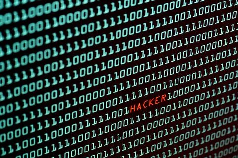 Hacker text and binary code concept from the desktop screen, selective foc... Stock-Fotos