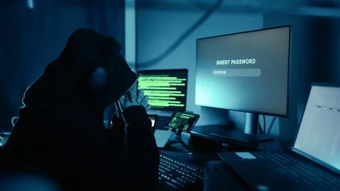 A hacker thinking security password, for login breaks into company data servers. Stock Photos