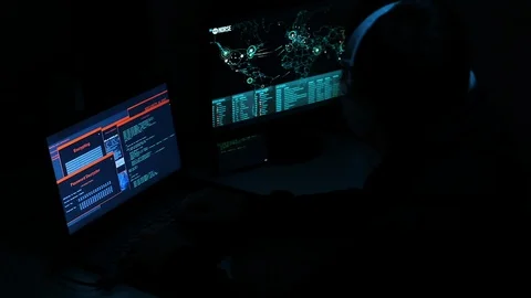 Hacker Typing and Works On A Computer with Data Display Screens World Map Stock Footage 128842102