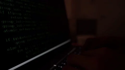 Hacker typing code in a laptop, interior ambient light, shallow depth of Stock Footage 122177777