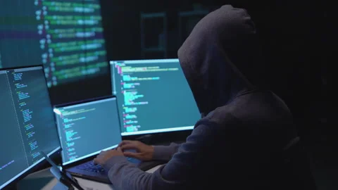 Hacker Typing Code on Multiple Screens in a Cybersecurity Environment Stock Footage 336679647